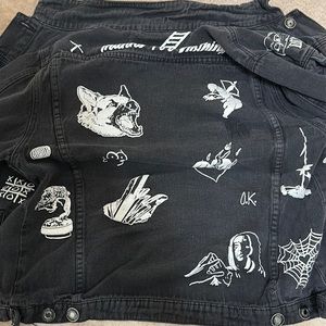 Black jean jacket w/ designs.